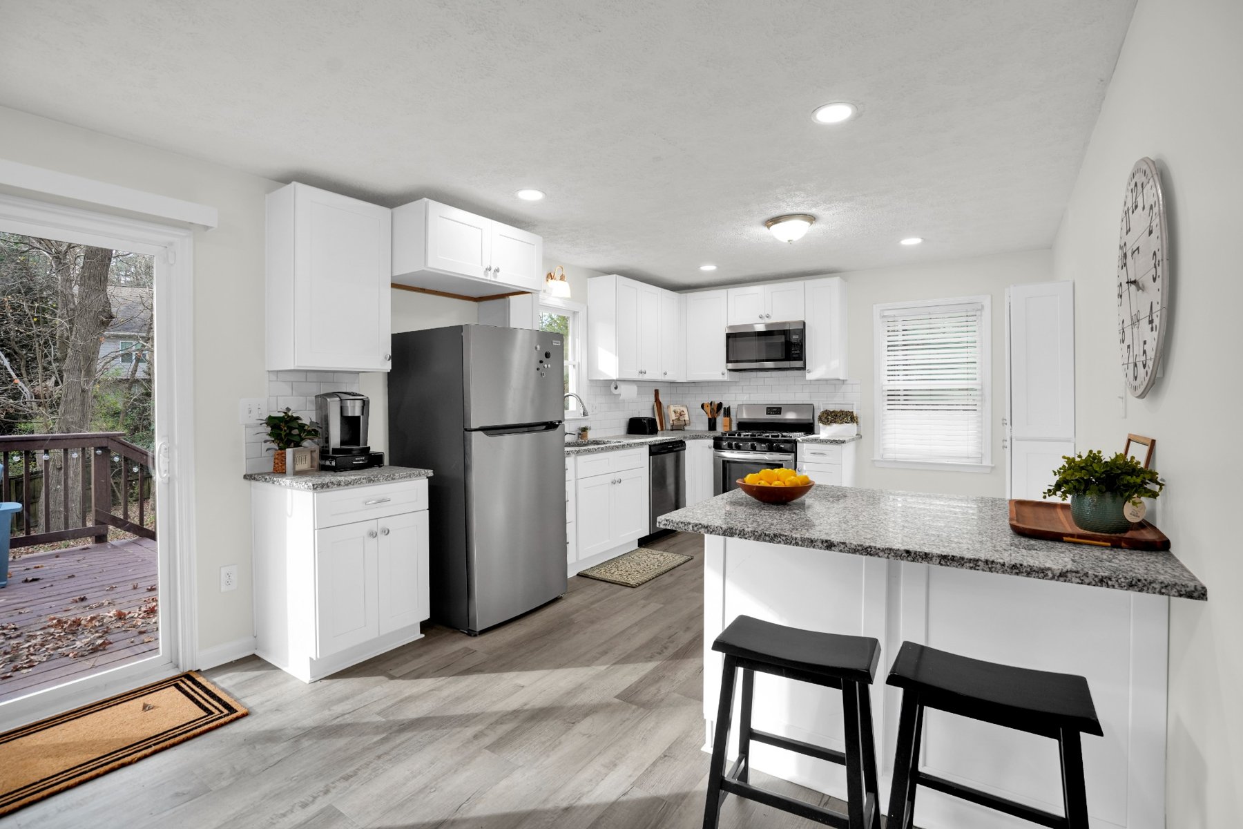 Bright kitchen with white cabinets and large island