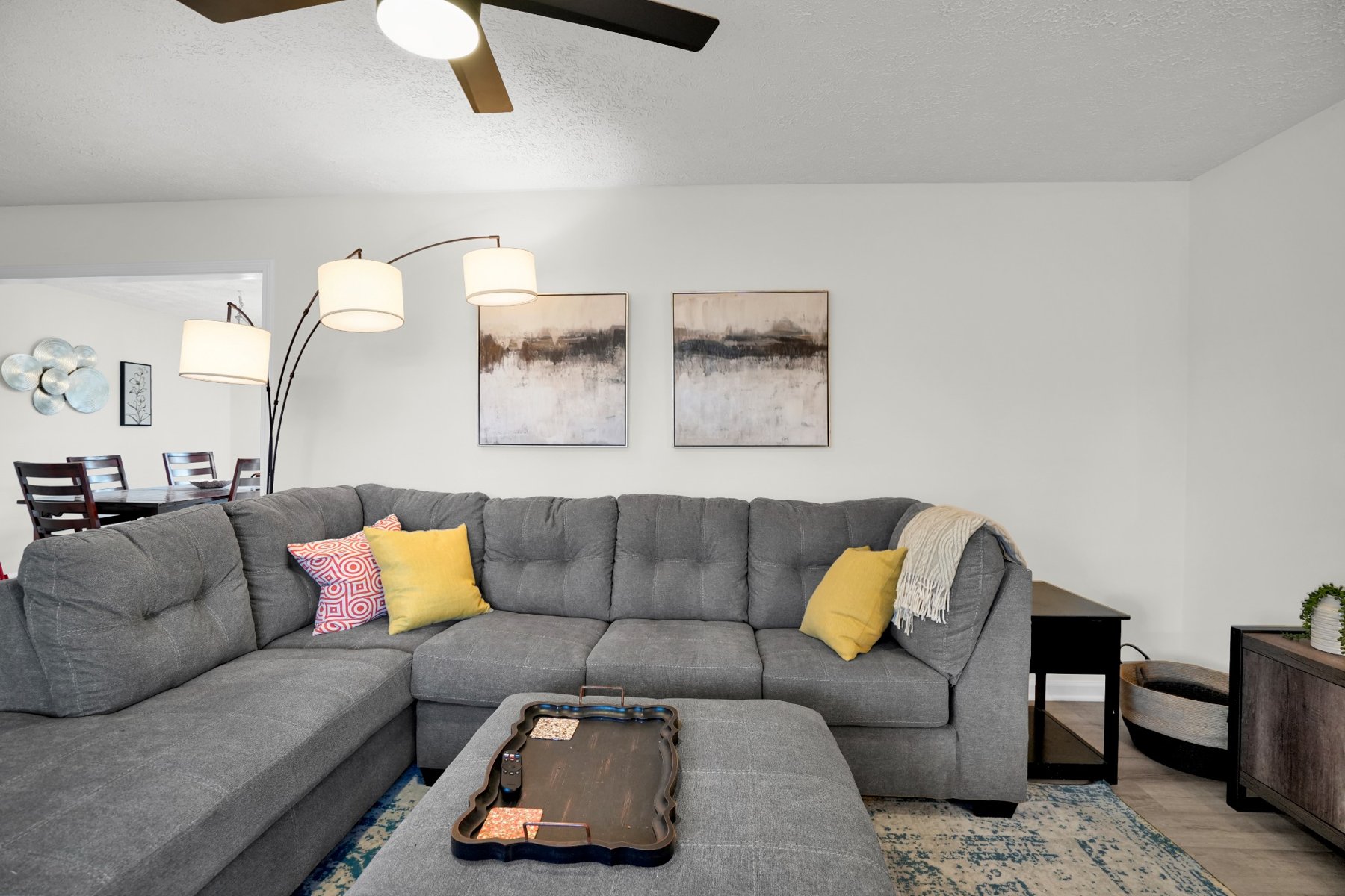 Living room with large sectional sofa, accent chairs, and television
